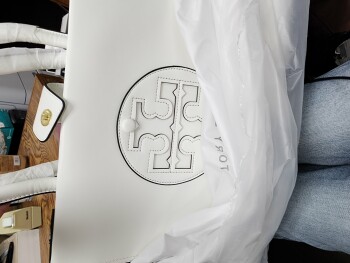 I am reporting that I received a white Tory Burch purse that I did NOT order. photo #1