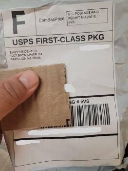 A package with a piece of cardboard square in it Foto #1