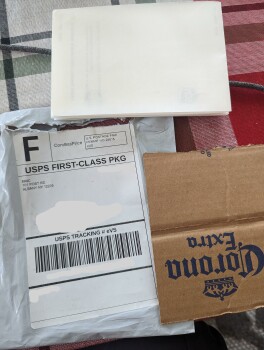 Received small package with a piece of cardboard and backs of USP stickers صورة فوتوغرافية #1