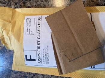 An empty envelope with two small pieces of cardboard photo #1