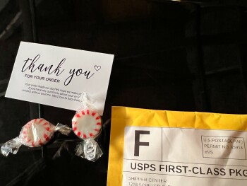 Two peppermint candies and a thank you business card from Shipper Center photo #1