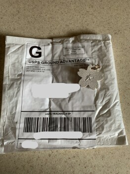 I received a package today a cheap white flower key chain that I did not order from EB shipping Dept photo #1